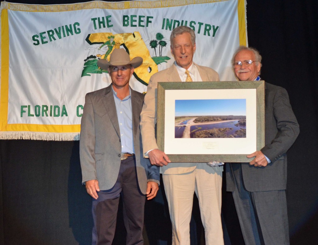 Charles Lee presents award to Charlie Lykes with Henry Kempfer FCA President